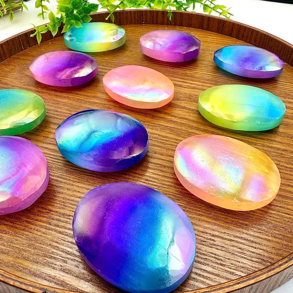 Aura coated selenite palm stones on a tray.