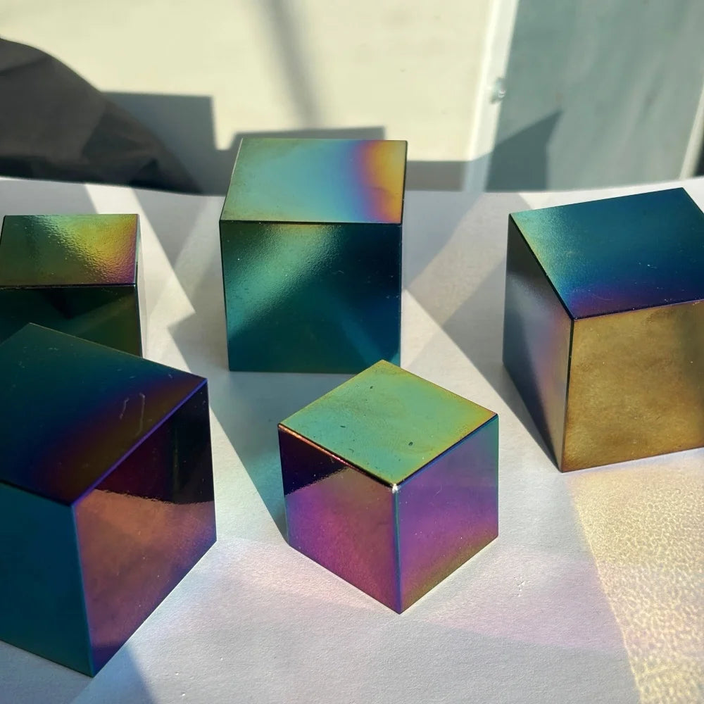 Polished natural obsidian cube with a vibrant iridescent finish, perfect for spiritual healing and bohemian decor.