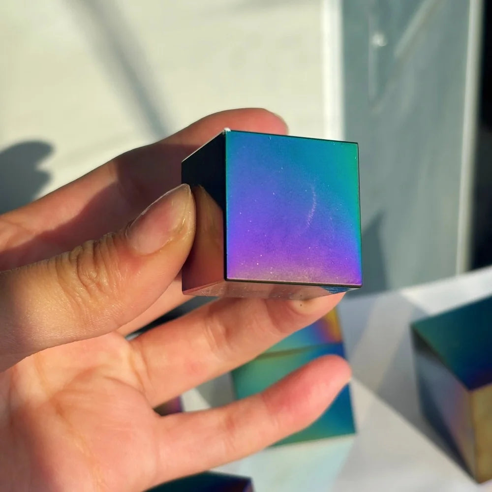 Polished natural obsidian cube with a vibrant iridescent finish, perfect for spiritual healing and bohemian decor.