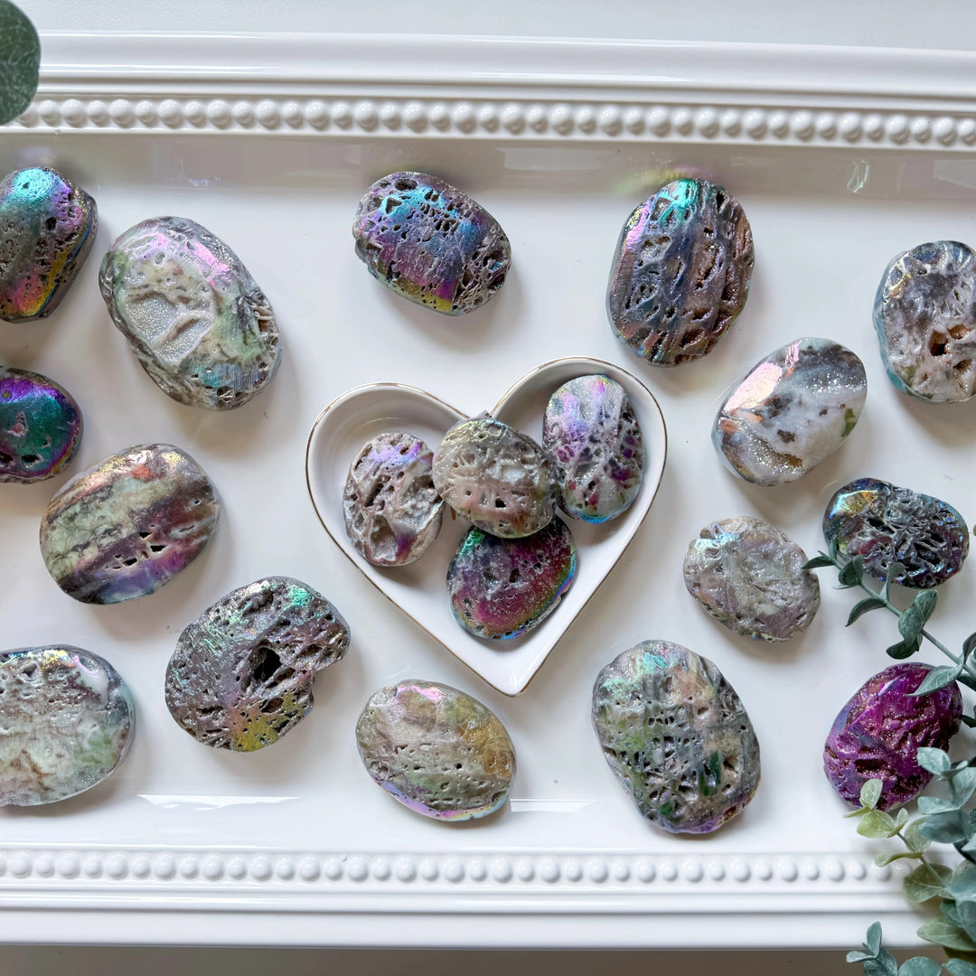 Iridescent Druzy Sphalerite Titanium Bubble Palm Stones with colorful, sparkling textures on a white tray.
