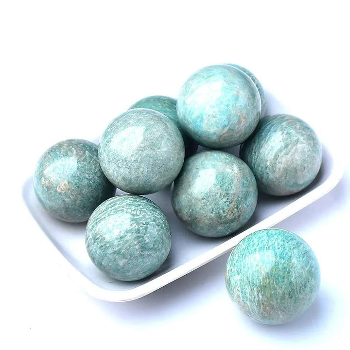 Polished natural Amazonite spheres in varying shades of blue-green, ideal for reiki healing and home decor.