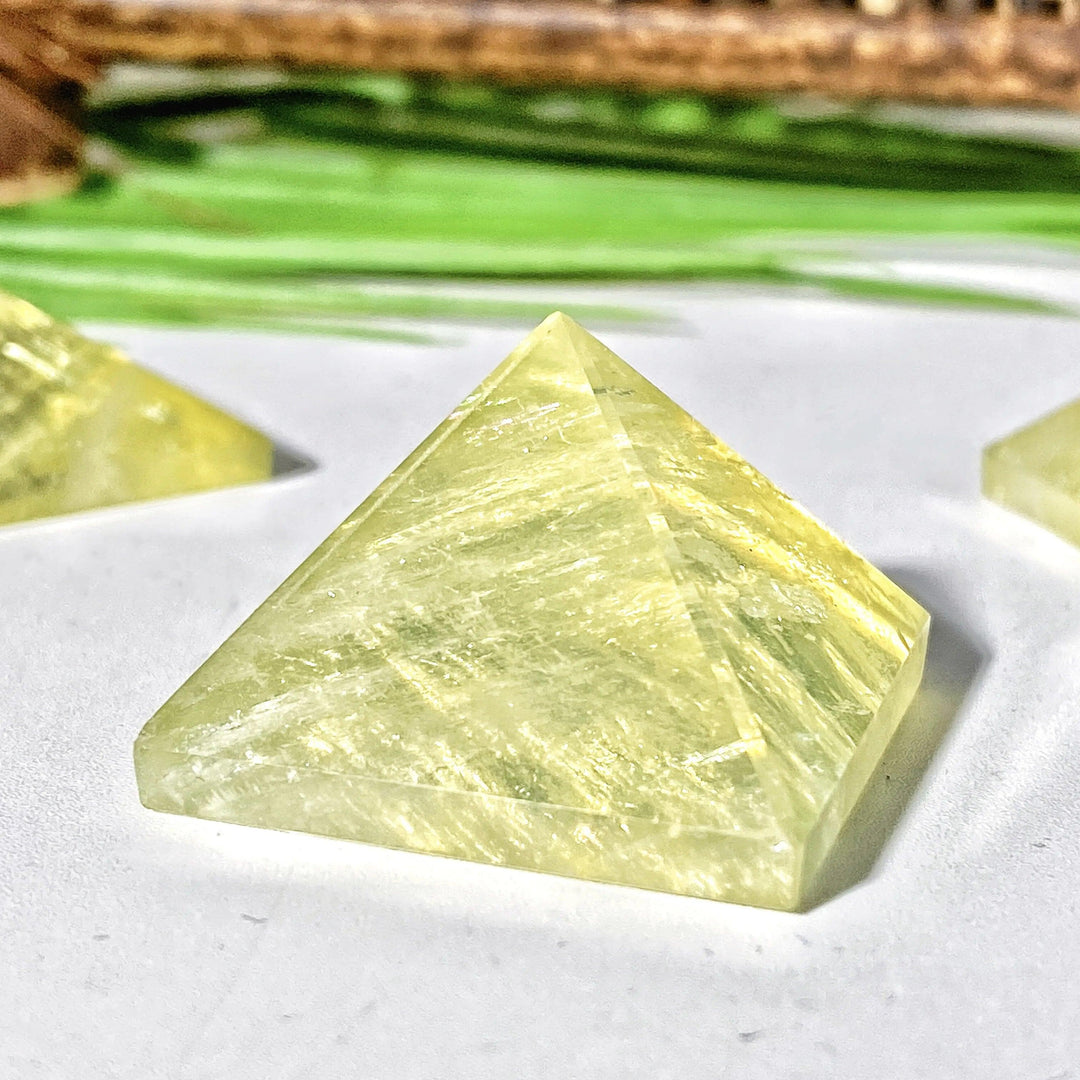 High-quality natural citrine crystal pyramid with a radiant yellow hue, perfect for healing energy and home decor.
