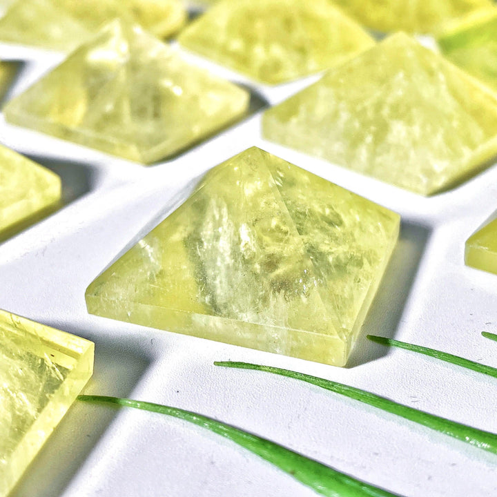 High-quality natural citrine crystal pyramid with a radiant yellow hue, perfect for healing decor and energy balancing.