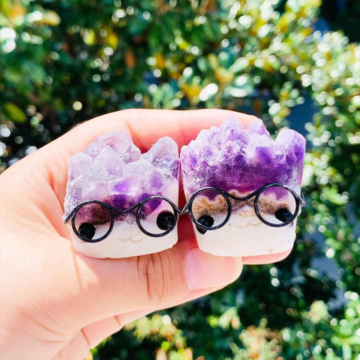 Two cute amethyst crystal cluster ornaments with mica, wearing tiny glasses, perfect for calming desk decor.