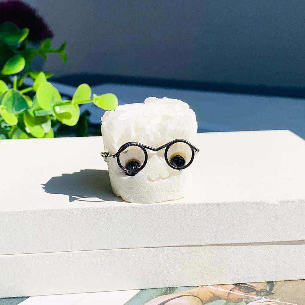 Natural white amethyst cluster hedgehog ornament wearing black glasses, a charming crystal desktop craft for home decor.