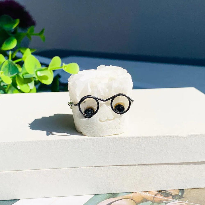 Natural white amethyst cluster hedgehog ornament wearing black glasses, a charming crystal desktop craft for home decor.