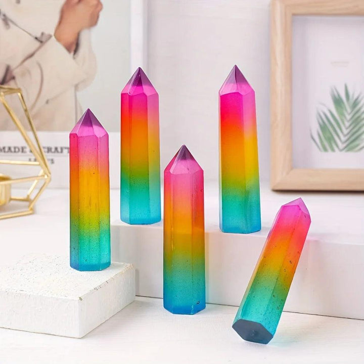 Vibrant rainbow aura selenite pillars with iridescent metallic colors, perfect for home decor and crystal healing.