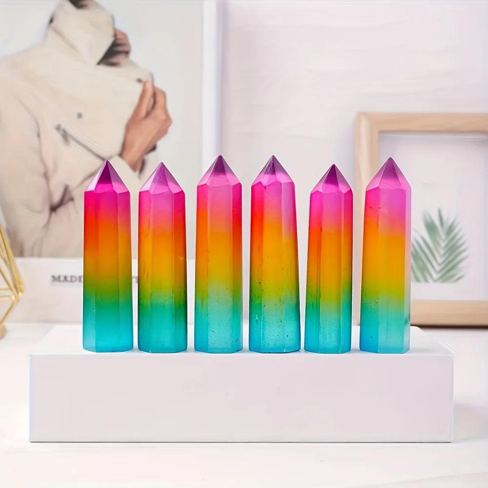 Vibrant rainbow aura selenite pillars with iridescent pink, yellow, and blue healing crystal points.