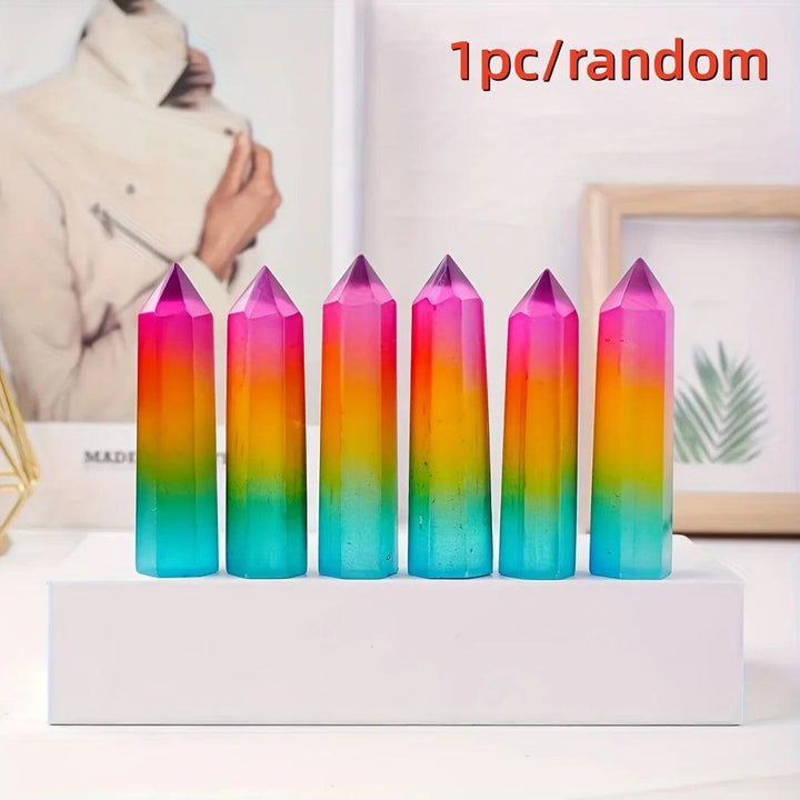 Vibrant rainbow aura selenite pillar crystal with iridescent pink, yellow, and blue metallic hues.