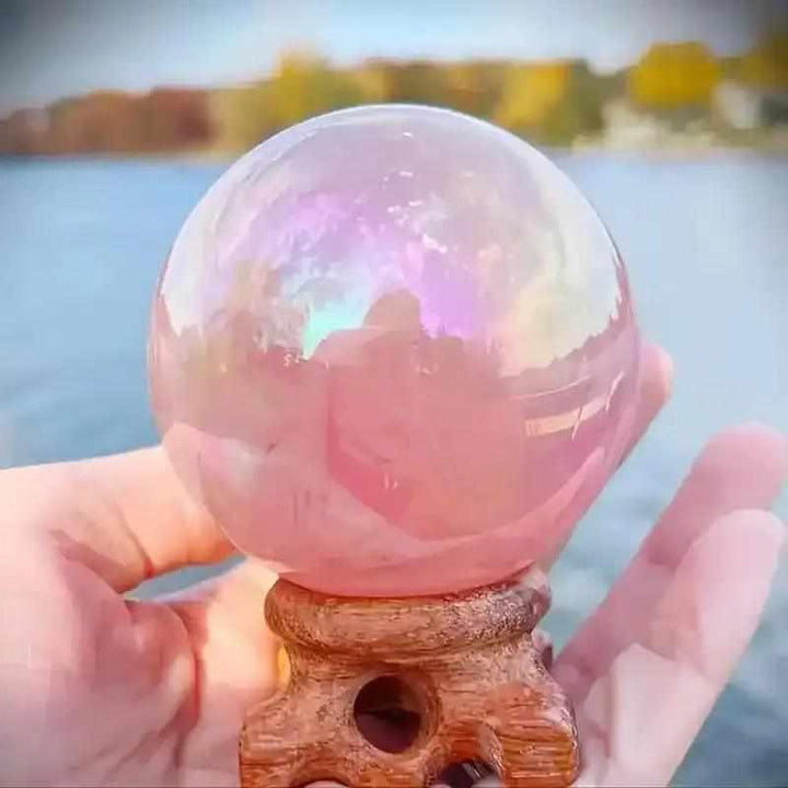 Gorgeous electroplated pink rose quartz sphere with an iridescent finish, perfect for love and healing energy.