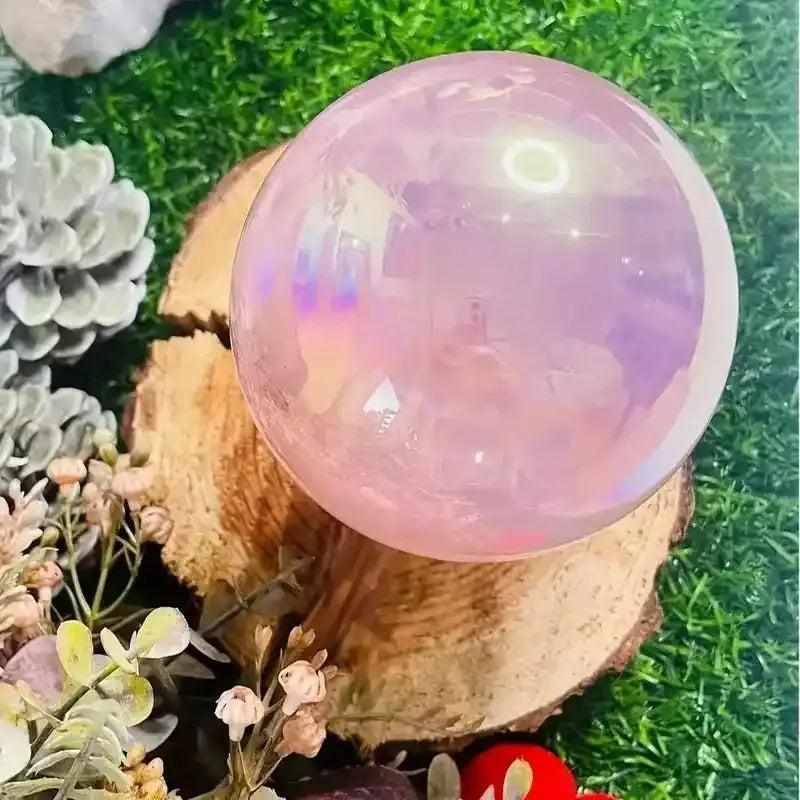 Gorgeous electroplated pink rose quartz sphere with an iridescent finish, perfect for healing and unique crystal gifting.