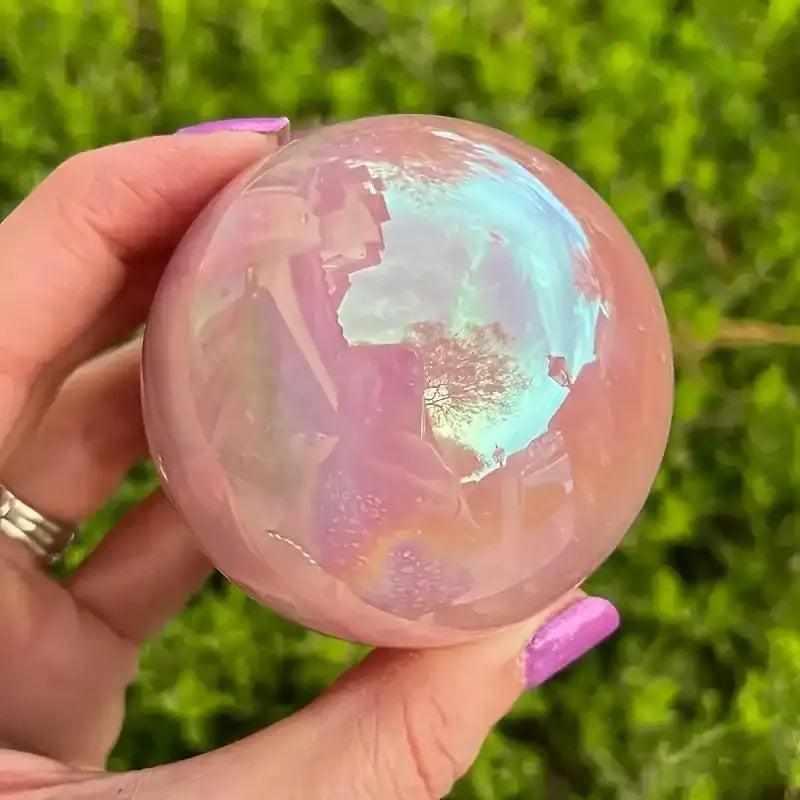 Gorgeous electroplated pink rose quartz sphere with an iridescent finish, perfect for healing and unique crystal gifting.