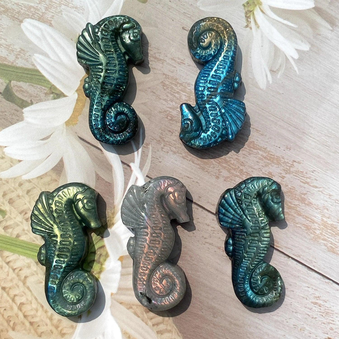 Handcrafted Labradorite seahorse crystal carvings featuring iridescent blue and green flashes for mystical home decor.