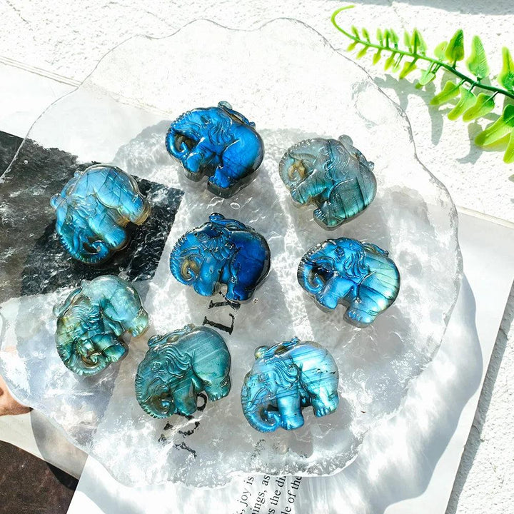 Handmade Labradorite elephant carvings featuring vibrant blue and golden flash, perfect for spiritual home decor.