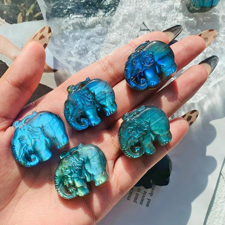 Handmade natural Labradorite elephant carvings featuring vibrant blue and golden flashes for spiritual home decor.