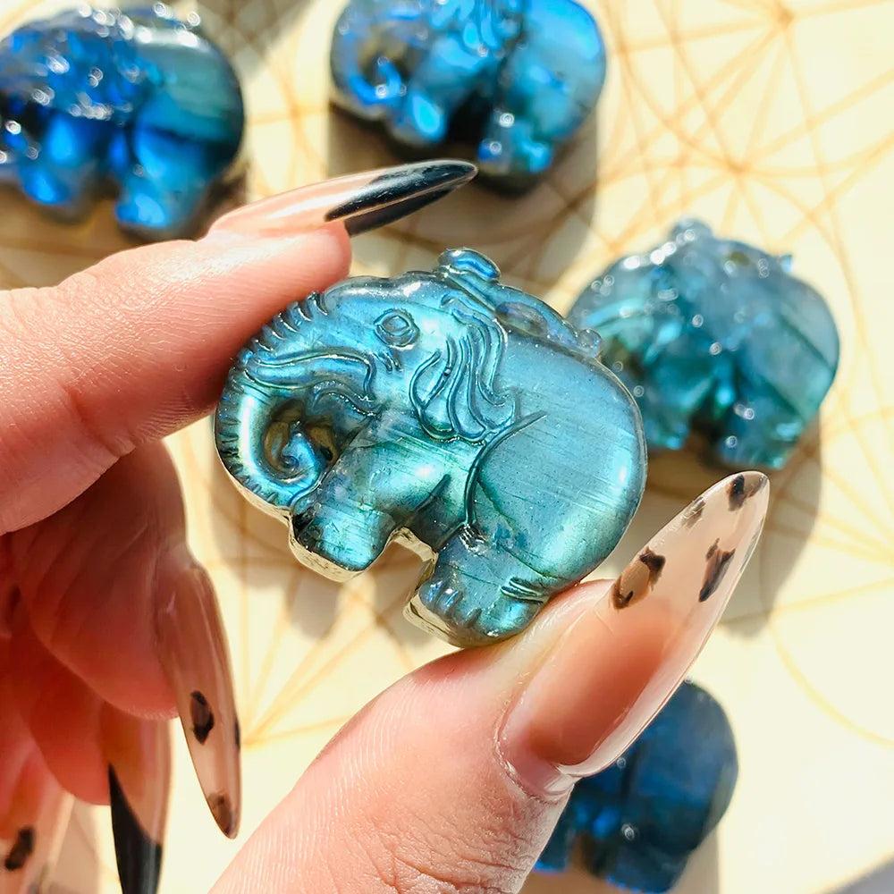 Handmade Labradorite elephant carving featuring vibrant blue and golden flash for spiritual healing and home decor.