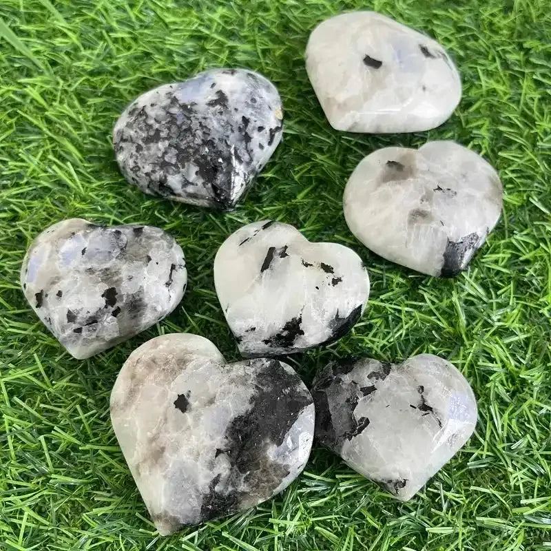 Polished natural black moonstone heart carvings for reiki healing and home decor, featuring unique crystal patterns.