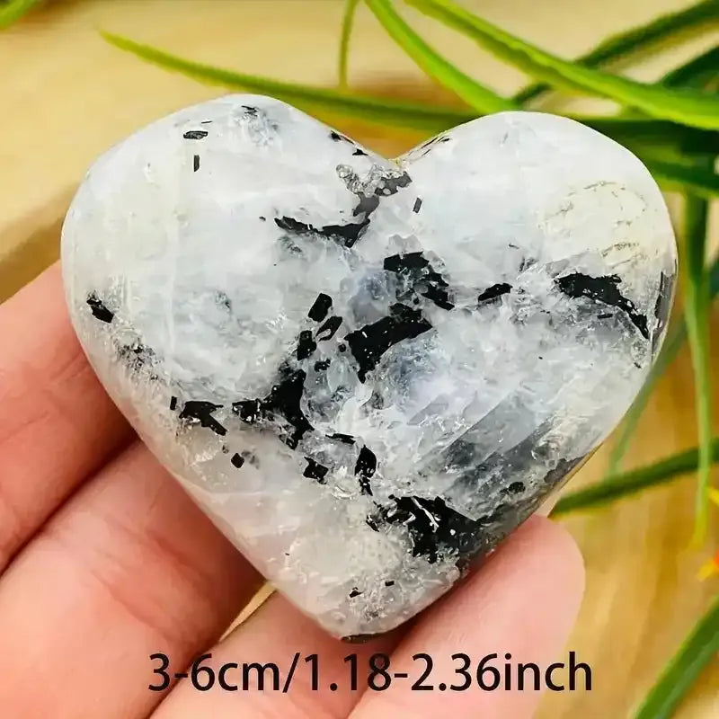 Polished black and white moonstone heart carving, perfect for reiki healing and elegant home decor.