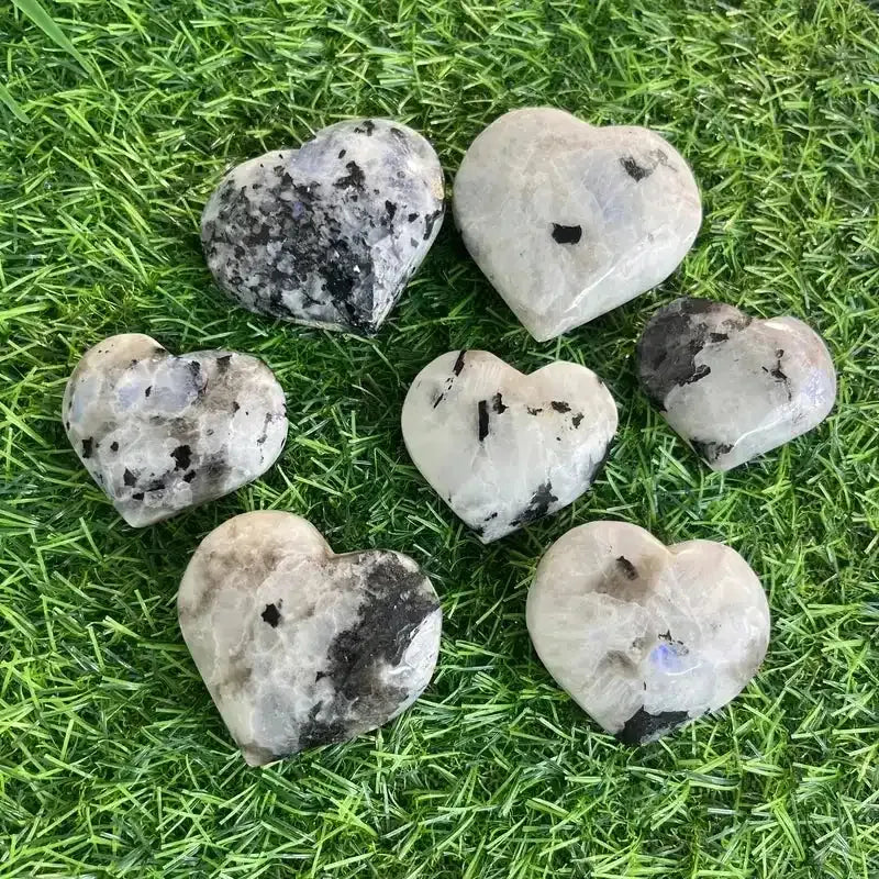 Polished natural black moonstone heart carvings for reiki healing and home decor, featuring unique crystal patterns.