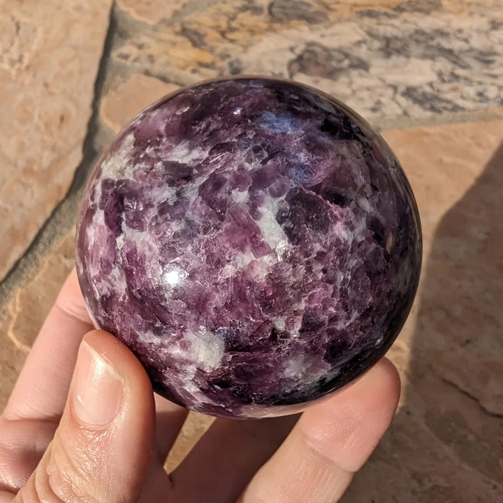 Polished natural Lepidolite crystal sphere with deep purple mica, perfect for calming boho home decor and energy healing.
