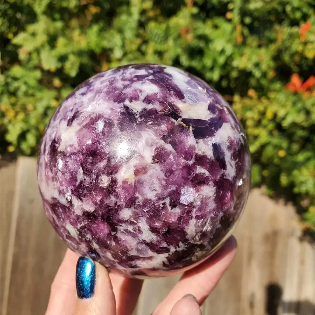 Polished natural Lepidolite sphere with deep purple mica, perfect as a calming boho crystal for elegant home decor.