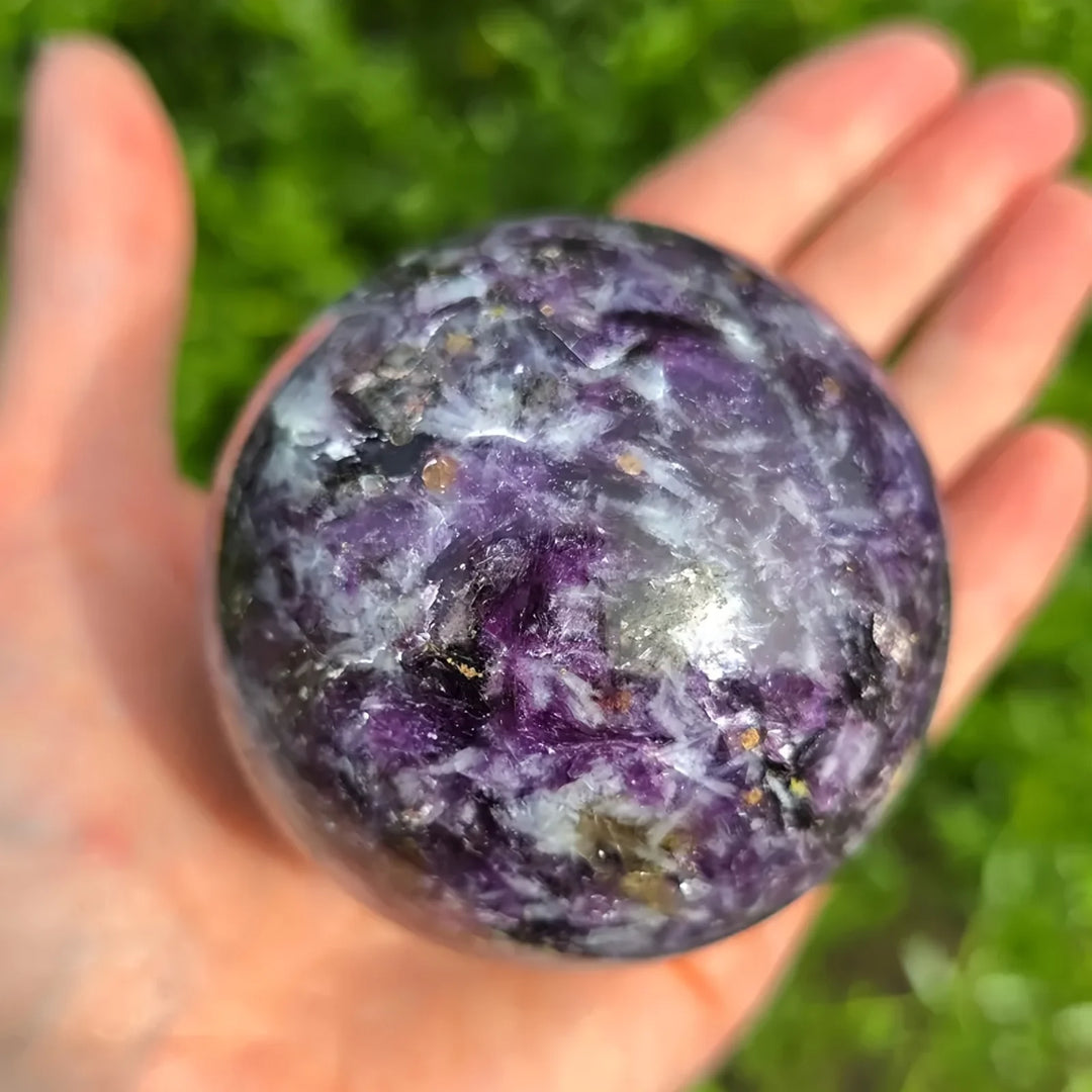 Polished natural Lepidolite sphere with purple mica swirls, perfect for calming boho home decor and crystal healing.