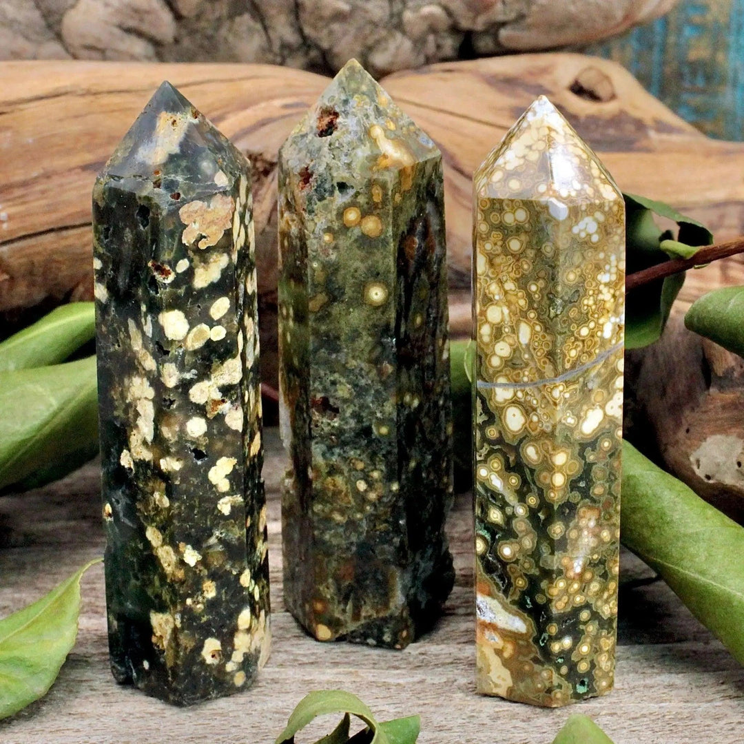 Three polished Ocean Jasper crystal pillars in earthy green and cream tones, perfect for healing and home decor.