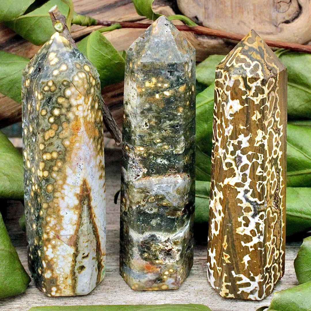 Three natural Ocean Jasper pillar crystals with unique green, brown, and white patterns for healing decor.