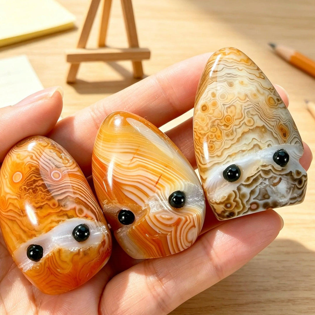 Hand-polished natural sardonyx crystal hedgehog pocket stones with banded orange and brown patterns for healing energy.