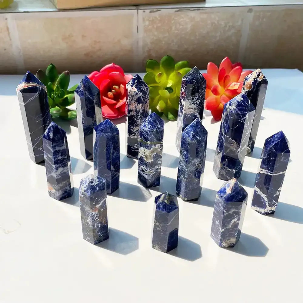 Polished Sodalite crystal point towers featuring deep blue hues and white veining, perfect for healing and home decor.