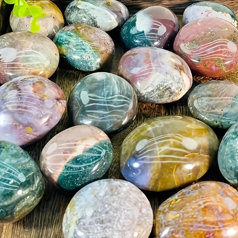 Polished Ocean Jasper palm stones in earthy green, pink, and yellow hues for healing home decor.