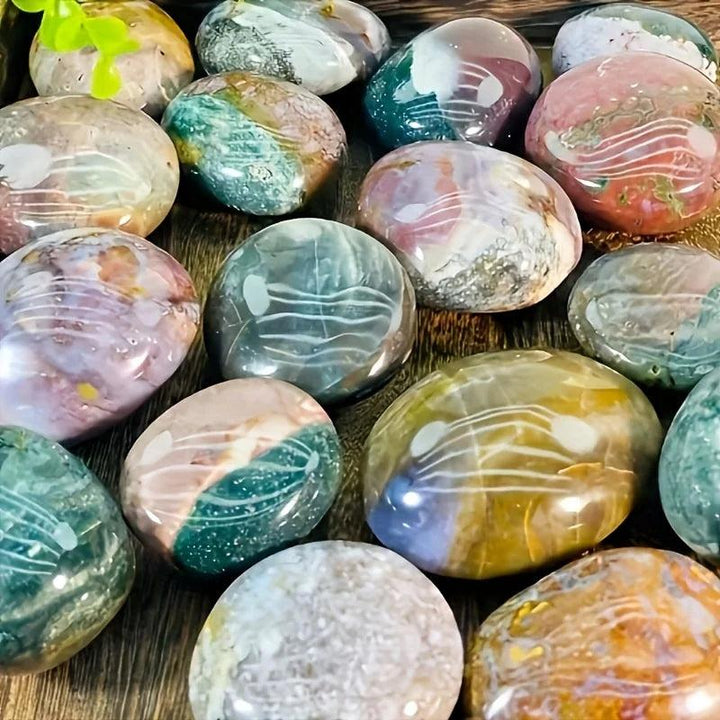 Polished Ocean Jasper palm stones in earthy green, pink, and yellow hues for healing home decor.