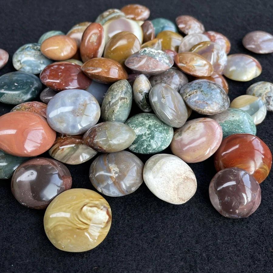 Polished Ocean Jasper palm stones in earthy green, red, and brown tones for healing and home decor.