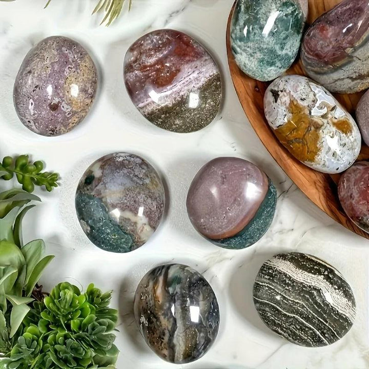 Polished Ocean Jasper palm stones in earthy green, pink, and brown tones for home decor and healing.