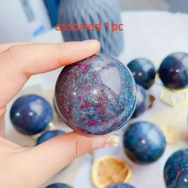 Polished Red and Blue Kyanite sphere for meditation and home decor, featuring a vibrant UV-reactive gemstone design.