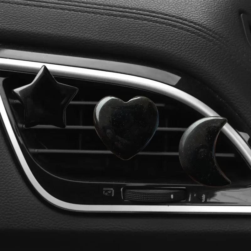 3Pcs/Set black replica crystal moon, star, and heart car air outlet decoration clips.