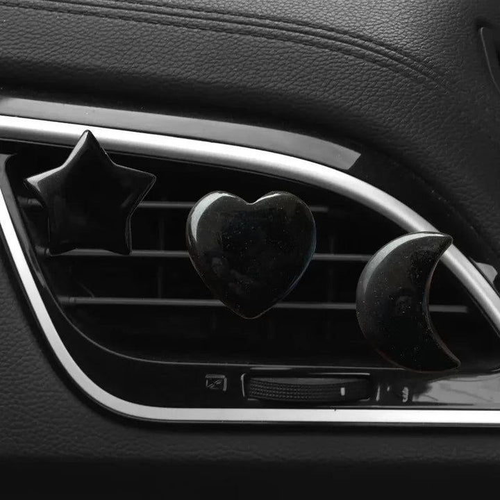 3Pcs/Set black replica crystal moon, star, and heart car air outlet decoration clips.