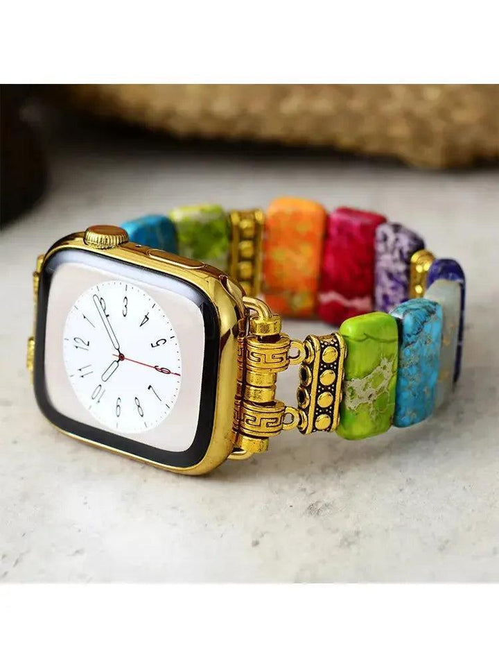 Crystal Destiny's 7 Chakra Imperial Jasper Apple iWatch band with colorful rectangular beads and gold-tone connectors.