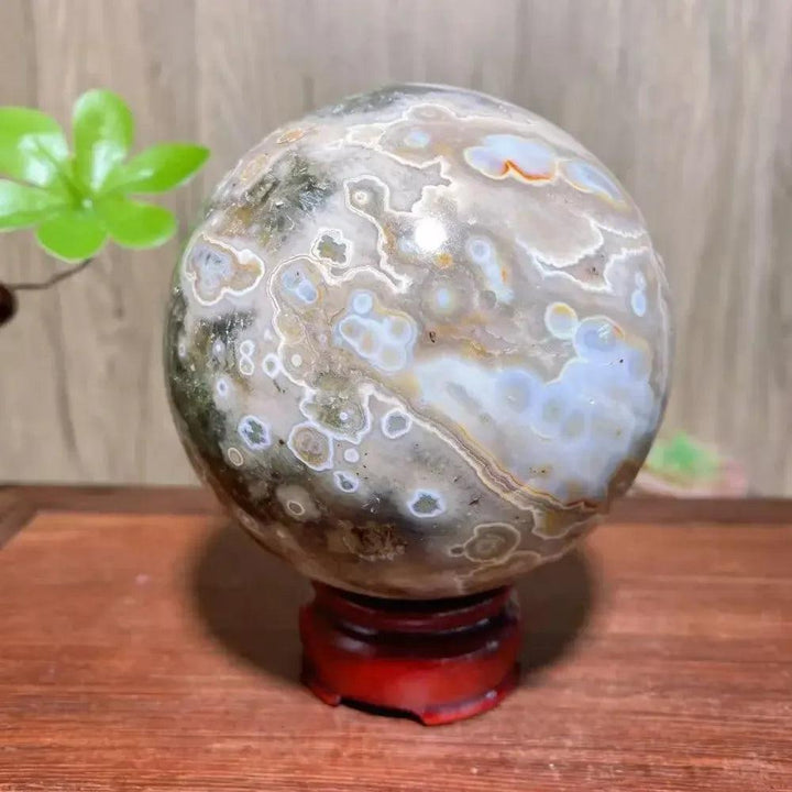 8th Vein Ocean Jasper geode sphere from Crystal Destiny, with polished white, green, and orange orbicular patterns.