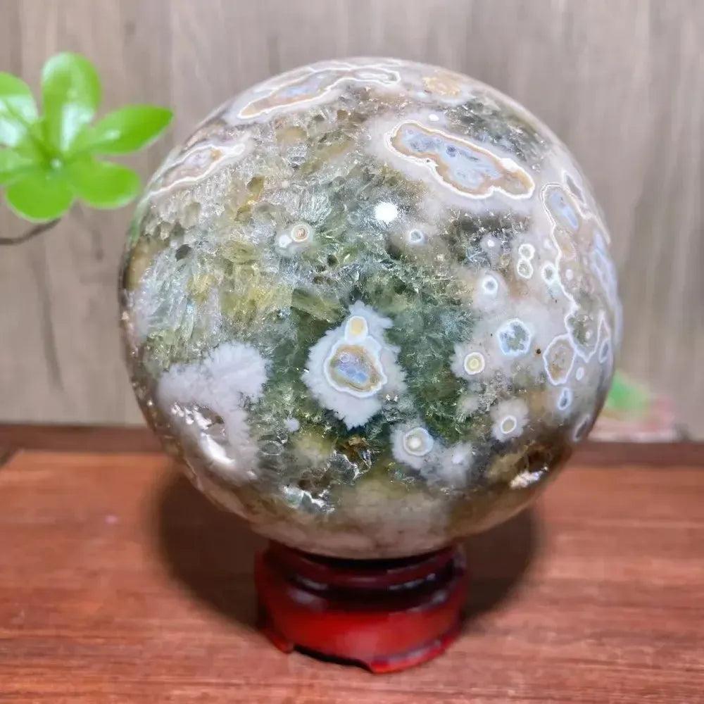 8th Vein Ocean Jasper geode sphere from Crystal Destiny, featuring green, white, and brown orbicular patterns with druzy.
