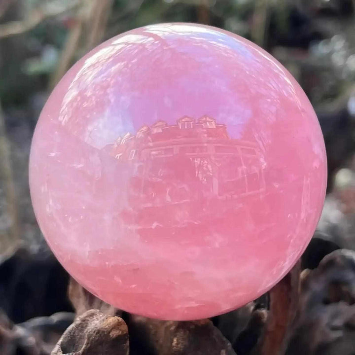 Large rose quartz crystal ball in deep pink, a natural stone sphere perfect for romantic decor and healing energy.