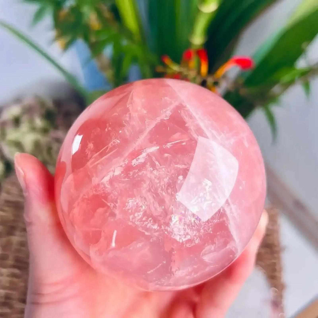 Large deep pink rose quartz crystal ball, a polished natural stone sphere perfect for romantic home decor and healing.