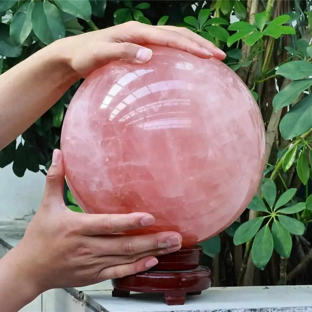 Large deep pink Rose Quartz crystal ball sphere, a polished natural stone for healing, weddings, and romantic home decor.