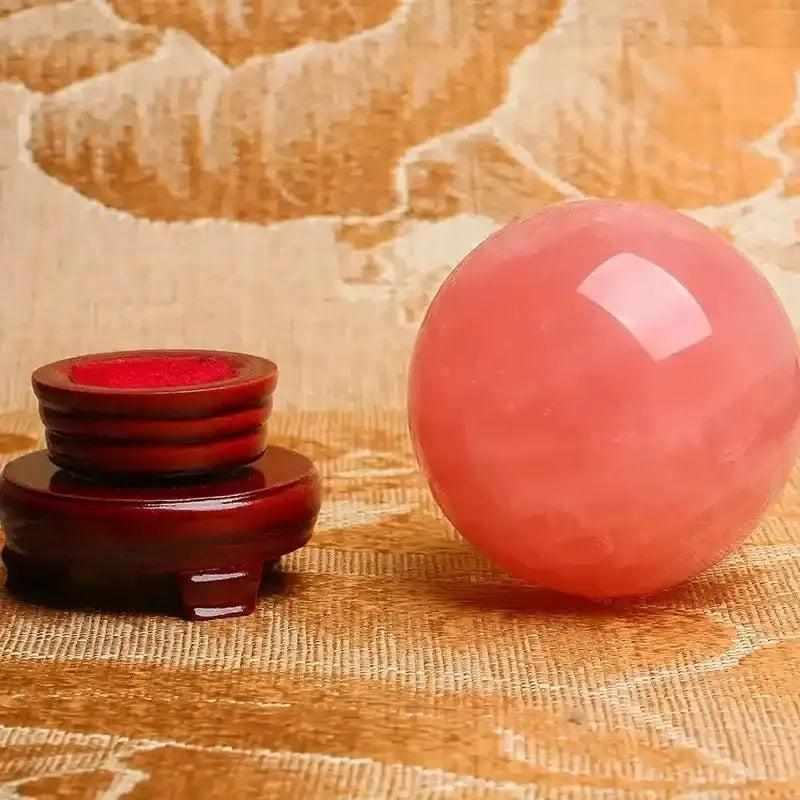 Large deep pink rose quartz crystal ball sphere, a perfect romantic bohemian decoration for weddings and home healing.