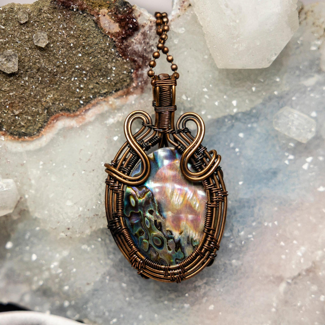 Iridescent Abalone Wire Wrap Pendant, 2.5" handcrafted in healing copper, showcasing shifting blues, greens, purples, and pinks.