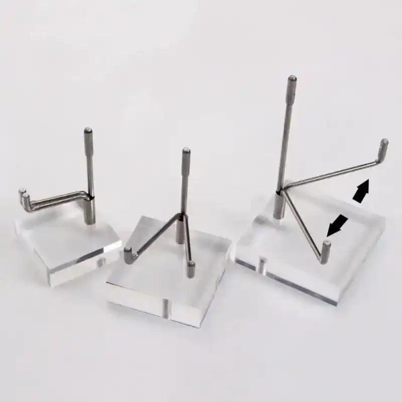 Three clear acrylic display stands with adjustable silver metal arms for crystals and gemstones.