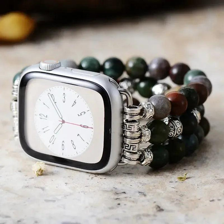 Agate beaded Apple Watch band with earthy green, brown, and gray stones, silver accents, promoting balance and grounding.