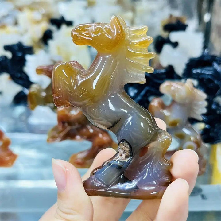 Hand-carved agate horse sculpture with translucent, earthy banding, perfect for grounding energy and desk decor.