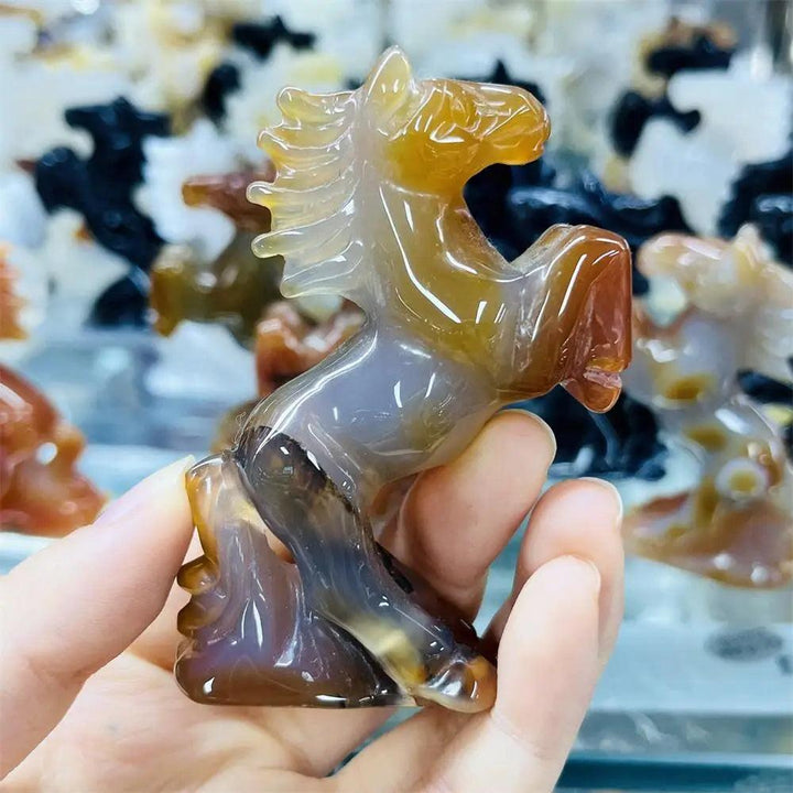 Hand-carved agate horse sculpture with translucent, banded earthy tones for grounding energy and balanced decor.