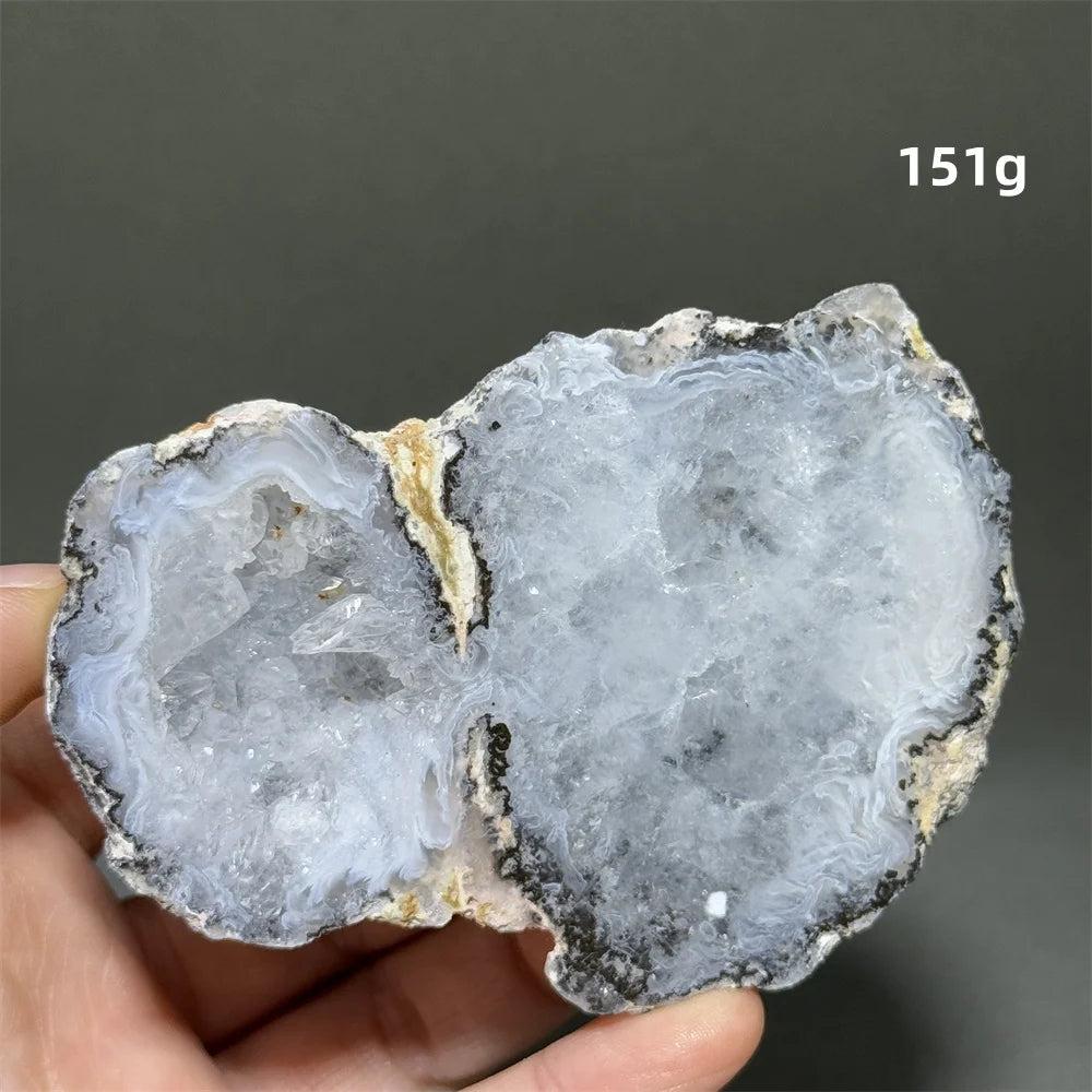 Natural Agate geode slice with sparkling white druzy crystals, banded gray and cream exterior.